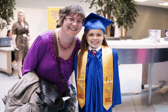 Adult and child at graduation ceremony